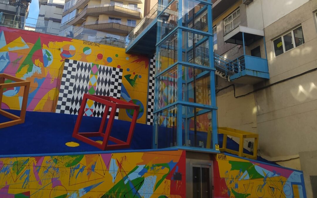 Pintar un mural en un edificio industrial en la zona del puerto.